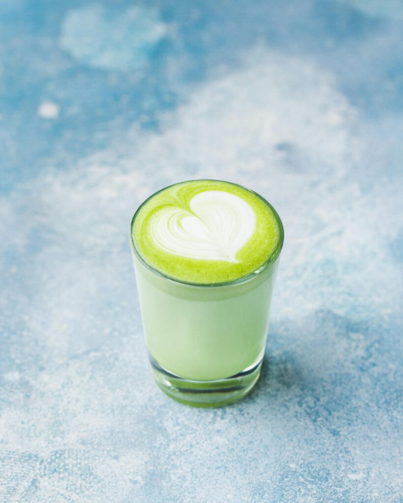 Delectable matcha latte with heart art, captured in a bright and artistic studio setting.